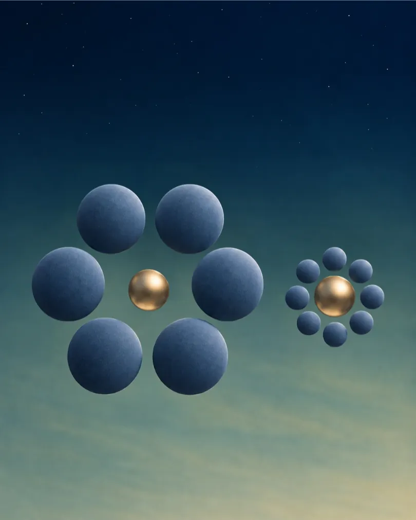 Two identical gold spheres, one ringed by large spheres and one by small spheres, so they look like different sizes