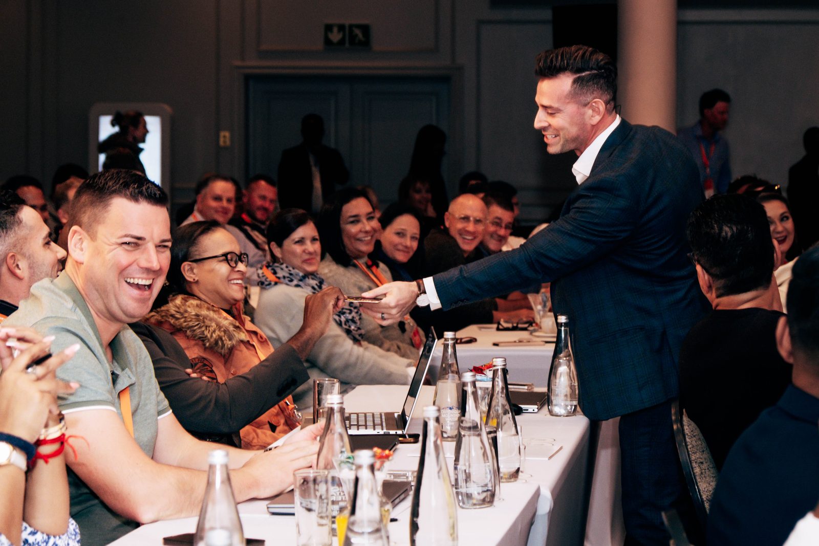 Gilan with a laughing audience at a corporate event